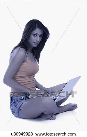 Woman using a laptop View Large Photo Image Stock Photo - Woman using a laptop. Fotosearch