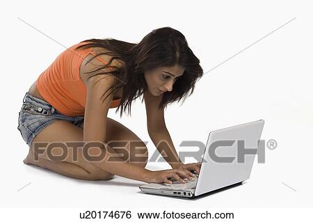 Woman using a laptop View Large Photo Image Stock Photograph - Woman using a laptop. Fotosearch