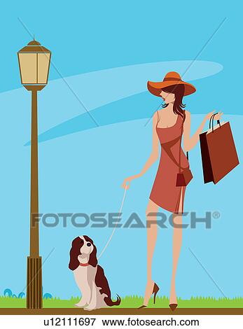 Woman walking in a street with her dog View Large Photo Image Stock Photo - Woman walking in a street with her dog. Fotosearch