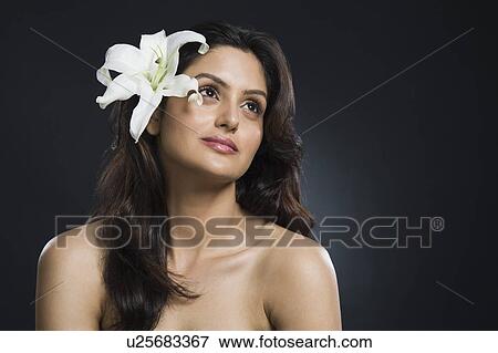 Woman wearing flowers and day dreaming View Large Photo Image Stock Photo - Woman wearing flowers and day dreaming. Fotosearch