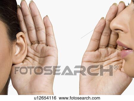 Woman whispering to her friend View Large Photo Image Stock Photograph - Woman whispering to her friend. Fotosearch