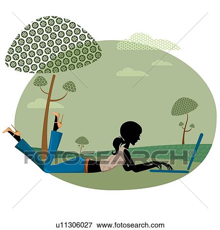 Stock Photo - Woman working on a laptop in a park. Fotosearch