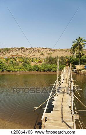 Wooden bridge across the river, Goa, India View Large Photo Image Stock Image - Wooden bridge across the river, Goa, India. Fotosearch