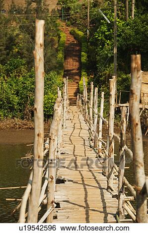 Wooden bridge across the river, Goa, India View Large Photo Image Stock Photograph - Wooden bridge across the river, Goa, India. Fotosearch