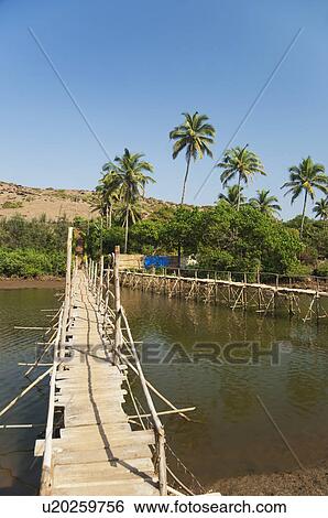 Wooden bridge across the river, Goa, India View Large Photo Image Stock Photograph - Wooden bridge across the river, Goa, India. Fotosearch