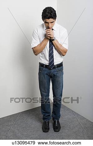 Worried university student standing in the corner View Large Photo Image Stock Photo - Worried university student standing in the corner. Fotosearch