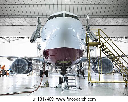 Airplane docked in hangar View Large Photo Image Stock Photo - Airplane docked in hangar. Fotosearch