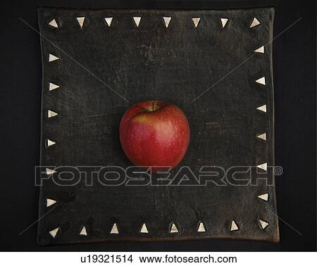Picture - Apple on decorative board. Fotosearch