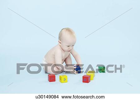 Baby boy playing with colored blocks View Large Photo Image Picture - Baby boy playing with colored blocks. Fotosearch