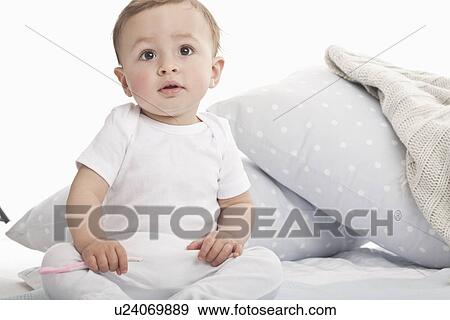 Baby sitting on couch View Large Photo Image Stock Photo - Baby sitting on couch. Fotosearch