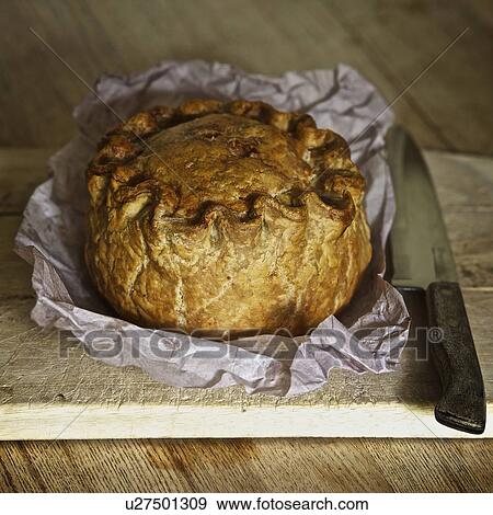 Baked pork pie on wooden board View Large Photo Image Stock Photo - Baked pork pie on wooden board. Fotosearch