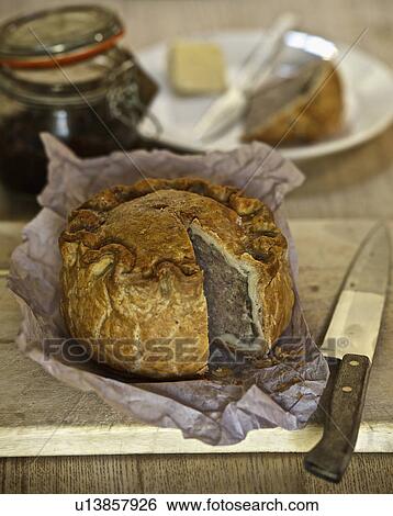 Baked pork pie on wooden board View Large Photo Image Stock Photograph - Baked pork pie on wooden board. Fotosearch