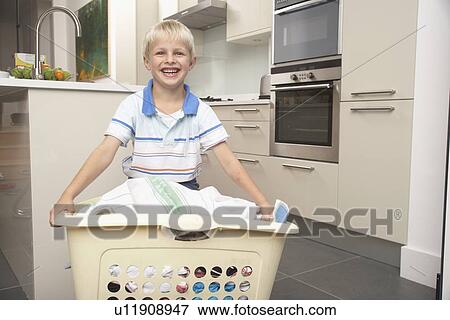 Stock Photo - Boy carrying basket of laundry. Fotosearch