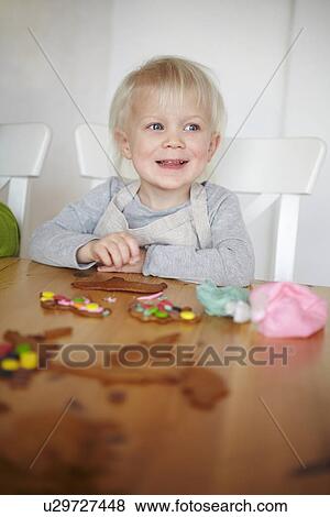 Boy decorating gingerbread cookies View Large Photo Image Stock Photo - Boy decorating gingerbread cookies. Fotosearch