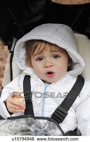 Stock Photo - Boy riding in stroller outdoors. Fotosearch