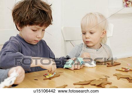Boys decorating gingerbread cookies View Large Photo Image Stock Image - Boys decorating gingerbread cookies. Fotosearch