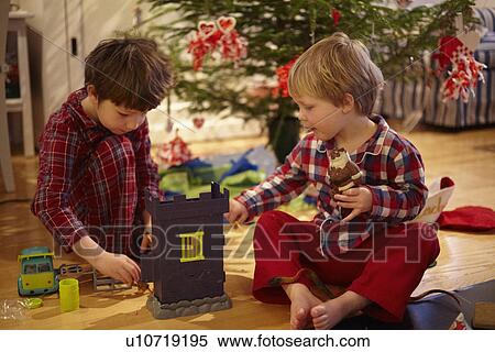 Boys opening Christmas gifts View Large Photo Image Stock Photography - Boys opening Christmas gifts. Fotosearch
