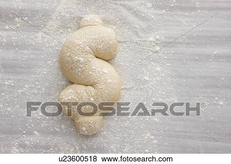 Stock Photo - Bread dough shaped in dollar sign. Fotosearch