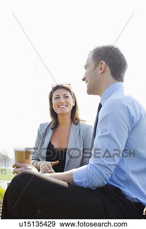 Business people drinking coffee outdoors View Large Photo Image Stock Photo - Business people drinking coffee outdoors. Fotosearch