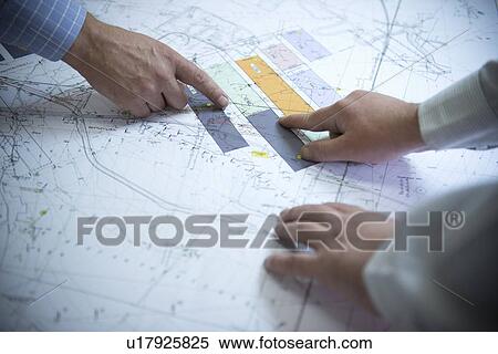 Business people reading coal mine plans View Large Photo Image Stock Photography - Business people reading coal mine plans. Fotosearch