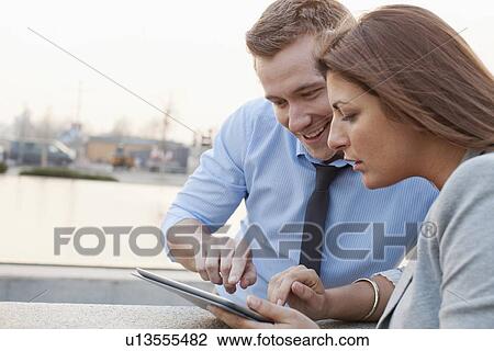 Business people using tablet computer View Large Photo Image Stock Image - Business people using tablet computer. Fotosearch