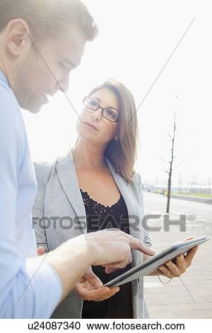 Business people using tablet computer View Large Photo Image Stock Image - Business people using tablet computer. Fotosearch