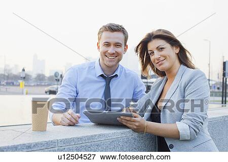 Business people using tablet computer View Large Photo Image Stock Photo - Business people using tablet computer. Fotosearch