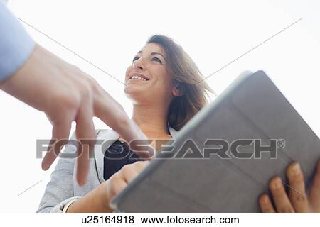 Business people using tablet computer View Large Photo Image Stock Photo - Business people using tablet computer. Fotosearch