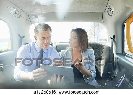 Stock Photograph - Business people using tablet computer. Fotosearch