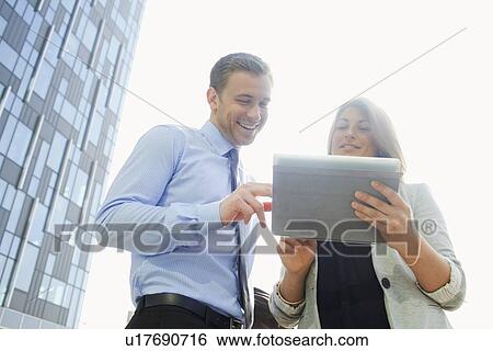 Business people using tablet computer View Large Photo Image Stock Photograph - Business people using tablet computer. Fotosearch