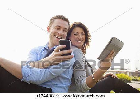 Business people using technology View Large Photo Image Stock Photo - Business people using technology. Fotosearch