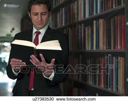 Businessman reading book in library View Large Photo Image Stock Image - Businessman reading book in library. Fotosearch