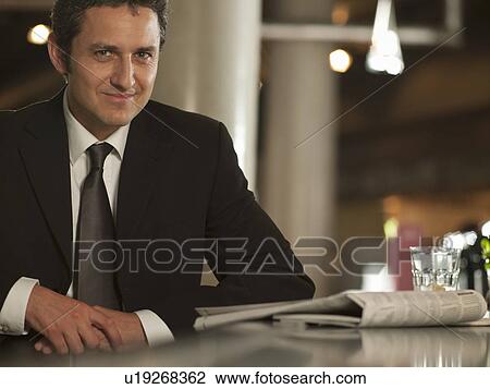 Businessman reading newspaper in cafe View Large Photo Image Stock Image - Businessman reading newspaper in cafe. Fotosearch