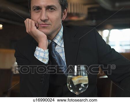 Businessman sitting at table in cafe View Large Photo Image Picture - Businessman sitting at table in cafe. Fotosearch