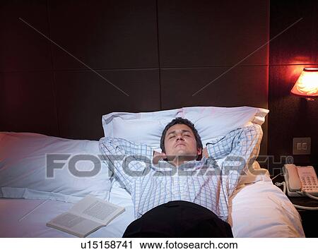 Businessman sleeping in hotel room View Large Photo Image Stock Image - Businessman sleeping in hotel room. Fotosearch