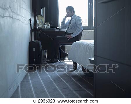 Stock Image - Businessman talking on cell phone. Fotosearch