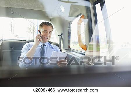 Stock Photograph - Businessman talking on cell phone. Fotosearch