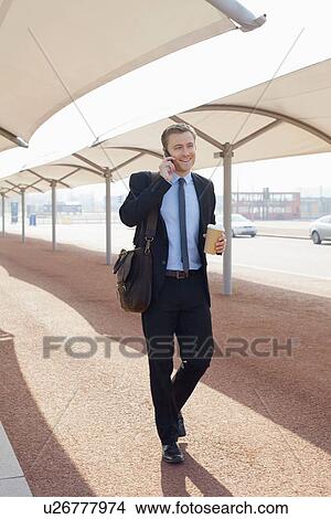 Businessman talking on city street View Large Photo Image Picture - Businessman talking on city street. Fotosearch