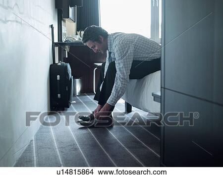 Businessman tying his shoes View Large Photo Image Picture - Businessman tying his shoes. Fotosearch