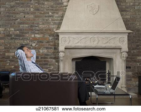 Businessman working on laptop at home View Large Photo Image Stock Image - Businessman working on laptop at home. Fotosearch