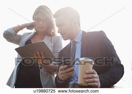 Stock Photography - Businesspeople using tablet computer. Fotosearch