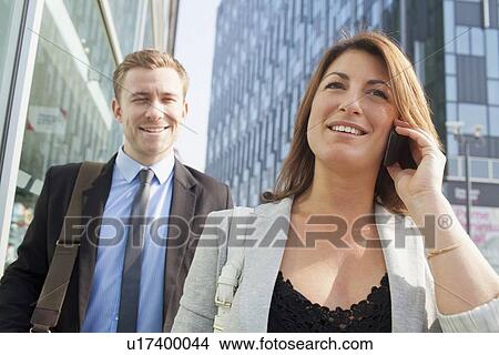 Businesspeople walking on city street View Large Photo Image Picture - Businesspeople walking on city street. Fotosearch