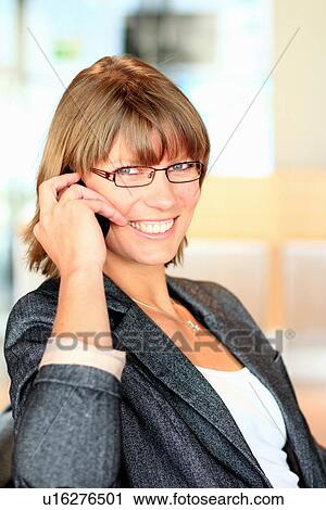 Stock Image - Businesswoman talking on cell phone. Fotosearch