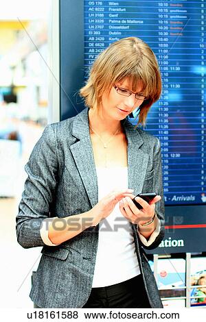 Stock Photo - Businesswoman using cell phone. Fotosearch