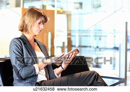Stock Photo - Businesswoman using tablet computer. Fotosearch