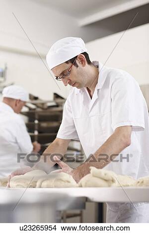 Picture - Chef baking in kitchen. Fotosearch