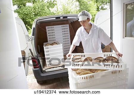 Chef carrying trays of bread to van View Large Photo Image Picture - Chef carrying trays of bread to van. Fotosearch
