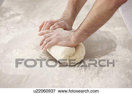 Chef kneading dough in kitchen View Large Photo Image Stock Photo - Chef kneading dough in kitchen. Fotosearch