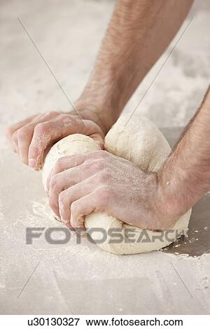 Chef kneading dough in kitchen View Large Photo Image Stock Photo - Chef kneading dough in kitchen. Fotosearch