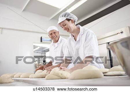 Chefs baking in kitchen View Large Photo Image Stock Photo - Chefs baking in kitchen. Fotosearch